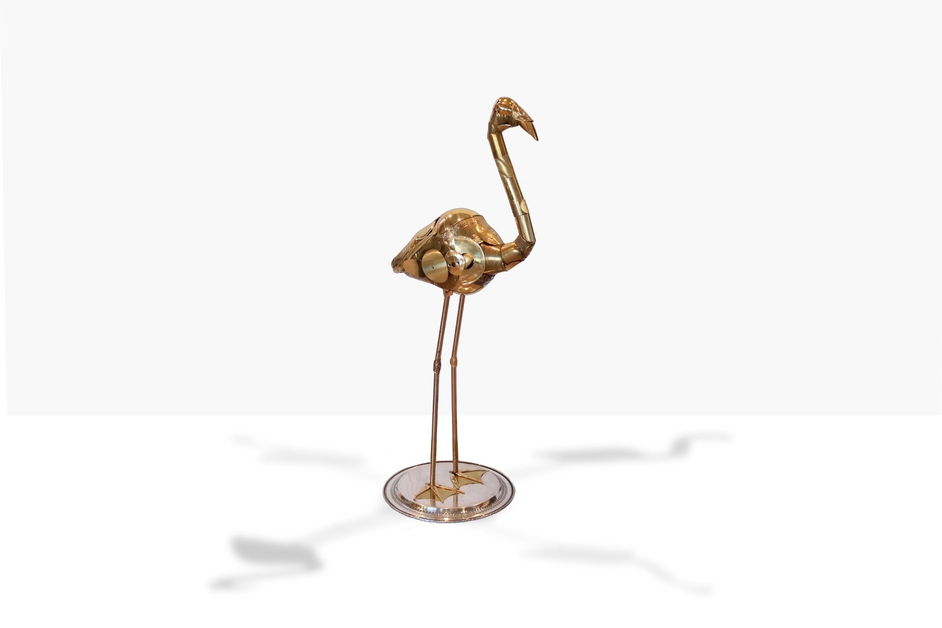 A flamingo sculpture assembled from brass and salvaged hardware by Leo Sewell